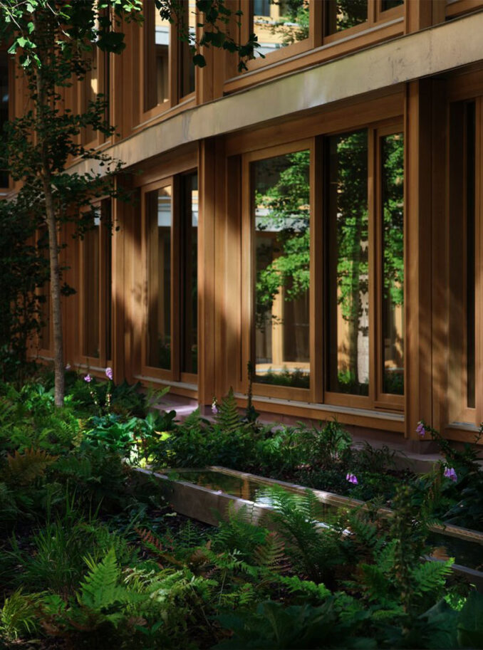Appleby Blue - Landscape Architect: Grant Associates - Looking at water feature in a courtyard in front of natural timber frame windows